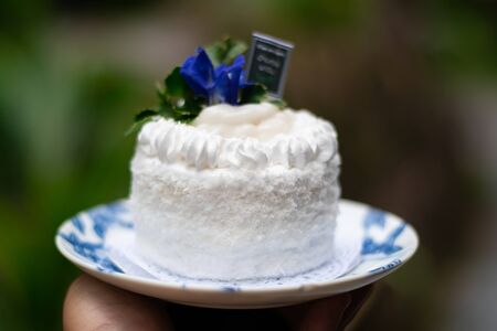 Coconut cake is a popular dessert in the Southern region of the United States. It is a cake frosted with a white frosting and covered in coconut flakes.の写真素材