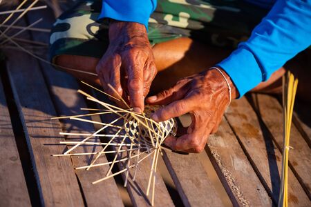 Basket weaving (also basketry or basket making) is the process of weaving or sewing pliable materials into two- or three dimensional artifacts, such as mats or containers.の写真素材