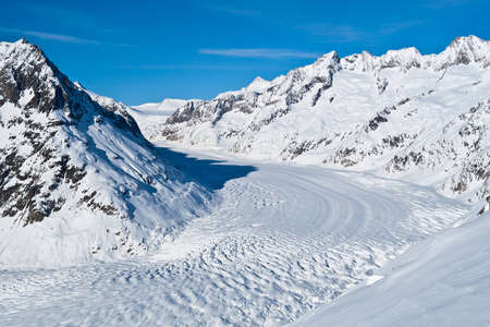 Bernese Alps, Canton of Valais, Switzerland  The Great Aletsch Glacier with blue sky and fresh snow...