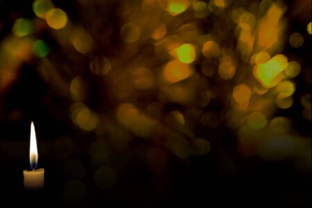 candle flame with abstract bokeh backgroundの写真素材