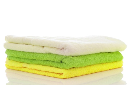 pile of lime and green towels on a white studio background for cutoutの写真素材