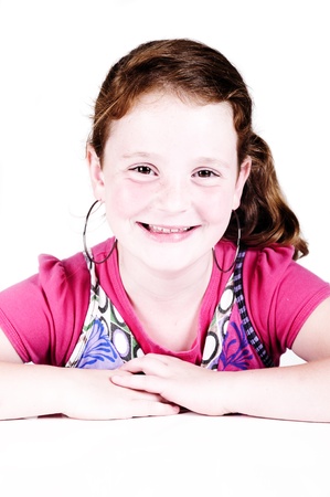 beautiful redhead smiling in a studio with a white backgroundの写真素材
