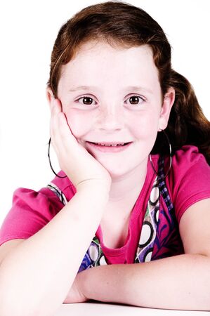 beautiful red haired girl smiling in a studio with white backgroundの写真素材