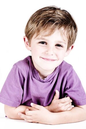 little boy taken in a studio with a white cutout backgroundの写真素材
