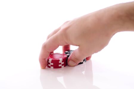 hand with red and black poker chipsの写真素材