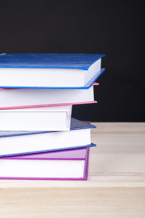 pile of five books for reading with a blackbackgroundの写真素材