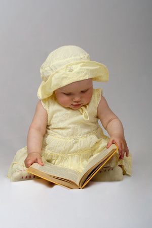 little girl read a book on white backgroundの写真素材