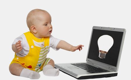 little girl touching screen on the laptopの写真素材