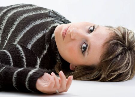 sexy brunette model lying on white backgroundの写真素材