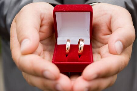 wedding rings in groom's handsの写真素材