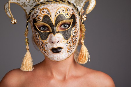 Portrait of beautiful young woman wearing carnival maskの写真素材