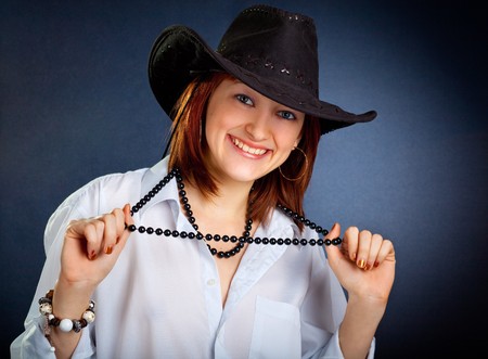 Portrait of young woman in dark cowboy hatの写真素材