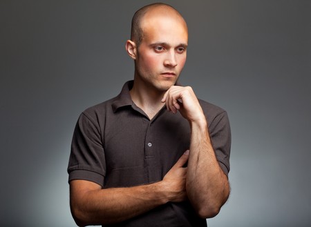 pensive young man in shirtの写真素材