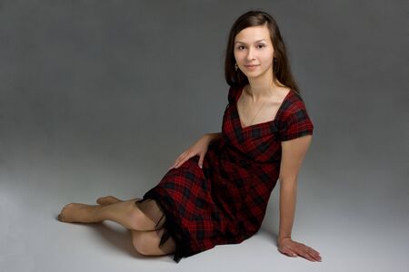 Young beautiful woman in dress posingの写真素材