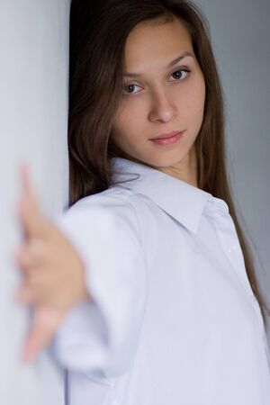 Glamour portrait of young woman at the wallの写真素材