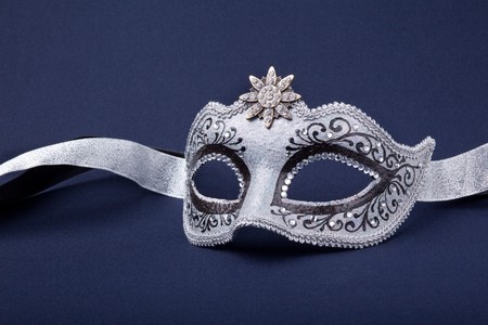 black and silver mask on dark  backgroundの写真素材