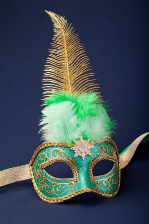 green and gold mask on dark  backgroundの写真素材