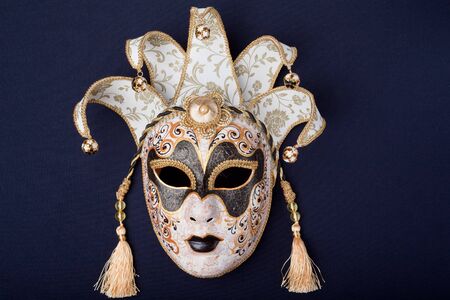 black and gold mask isolated on a black backgroundの写真素材