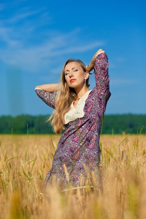 young beauty girl in the wheat fieldの写真素材
