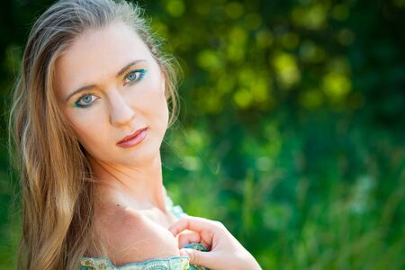 beautiful woman among green leaves in the forestの写真素材