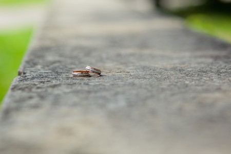 gold and silver wedding rings on grayの写真素材
