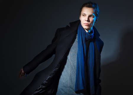 attractive young man wearing elegant black suit の写真素材