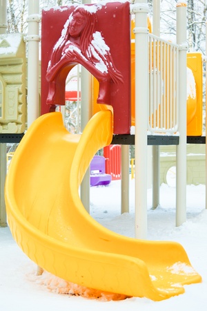 Playground  under snow in winter forestの写真素材