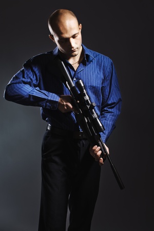 Portrait of a handsome young man holding a gun.の写真素材