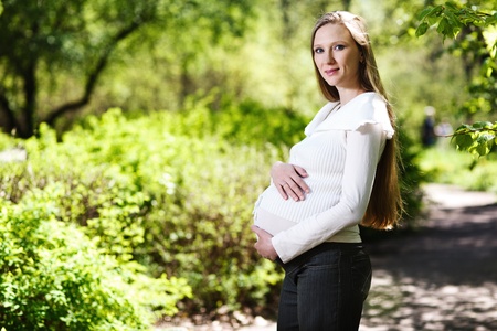 Beautiful pregnant woman relaxing in the parkの写真素材