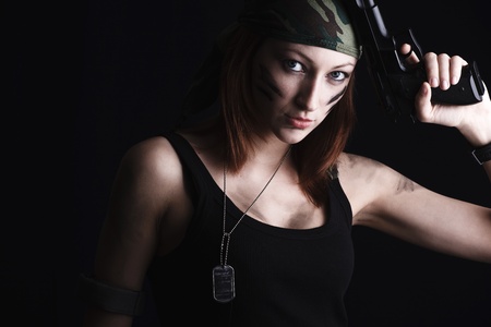 Sexy woman holding gun on darkの写真素材