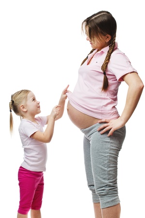 Beautiful pregnant woman with her daughter  Isolated on white backgroundの写真素材
