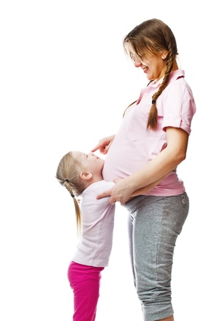 Beautiful pregnant woman with her daughter  Isolated on white backgroundの写真素材