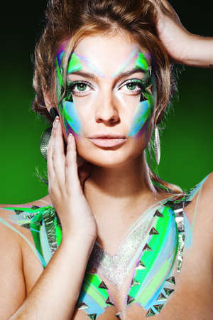 Studio shot of a blond woman with colorful makeupの写真素材