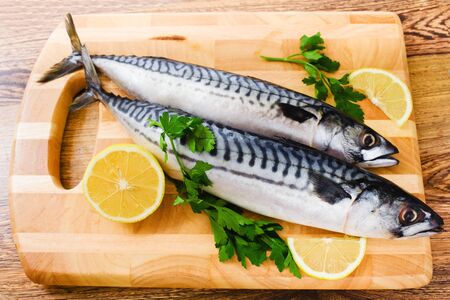 couple of fresh mackerel on woodの写真素材