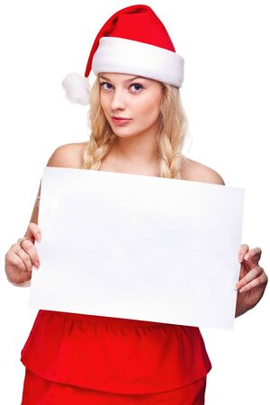 Beautiful christmas woman in santa hat holding empty boardの写真素材