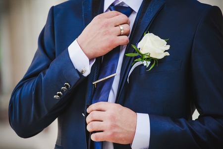 Groom set the bowtie straightの写真素材