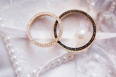 gold wedding rings on white