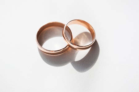 gold wedding rings on whiteの写真素材