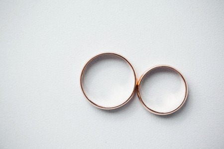 gold wedding rings on whiteの写真素材