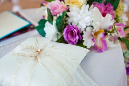 gold wedding rings on the pincushionの写真素材