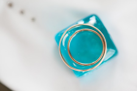 gold wedding rings on whiteの写真素材
