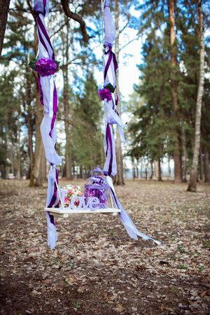 Wedding decoration of a beautiful delicate bouquet lying down on a swingの写真素材