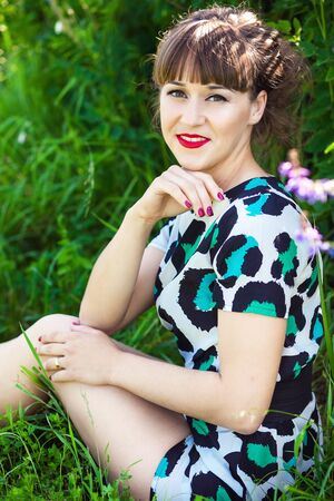 Fashion portrait of young sensual woman in garden. Beauty summertimeの写真素材