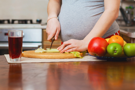 beautiful pregnant woman on kitchen with healthy foodの写真素材