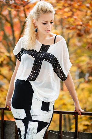 Beautiful Woman in dress and old arhitecture on Fall Nature Backgroundの写真素材