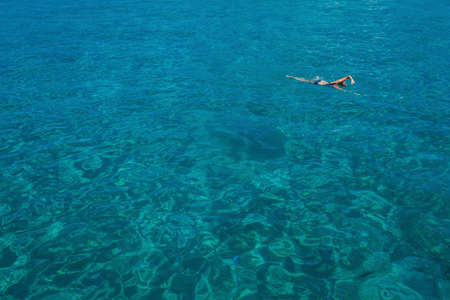 Aerial view of swimming beautiful woman
