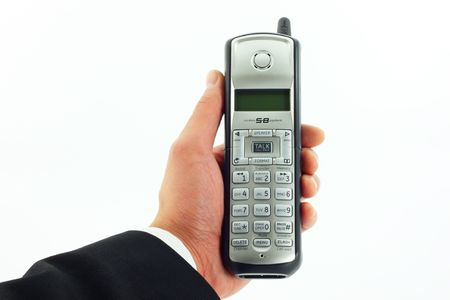 Business man's hand holding a cordless phoneの写真素材