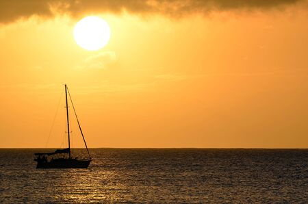 Sailboat Sunset Landscape Over Hawaii Ocean Watersの写真素材