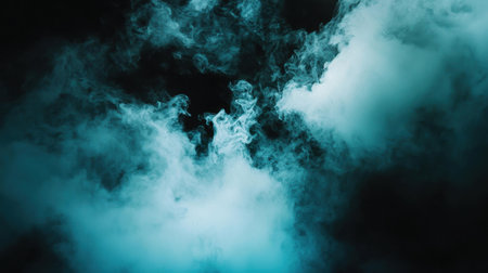 Explore the mesmerizing beauty of blue smoke swirls on a dark background. This ethereal image captures the essence of mystery and elegance with its fluid motion.の素材
