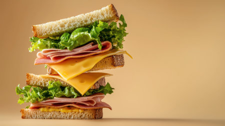 Enjoy this vibrant close-up of a delicious sandwich stacked high with fresh lettuce, ham, and cheese, perfect for a quick meal or picnic delight.の素材